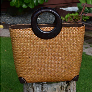 Wheat coloured handwoven bag with dark wood handles