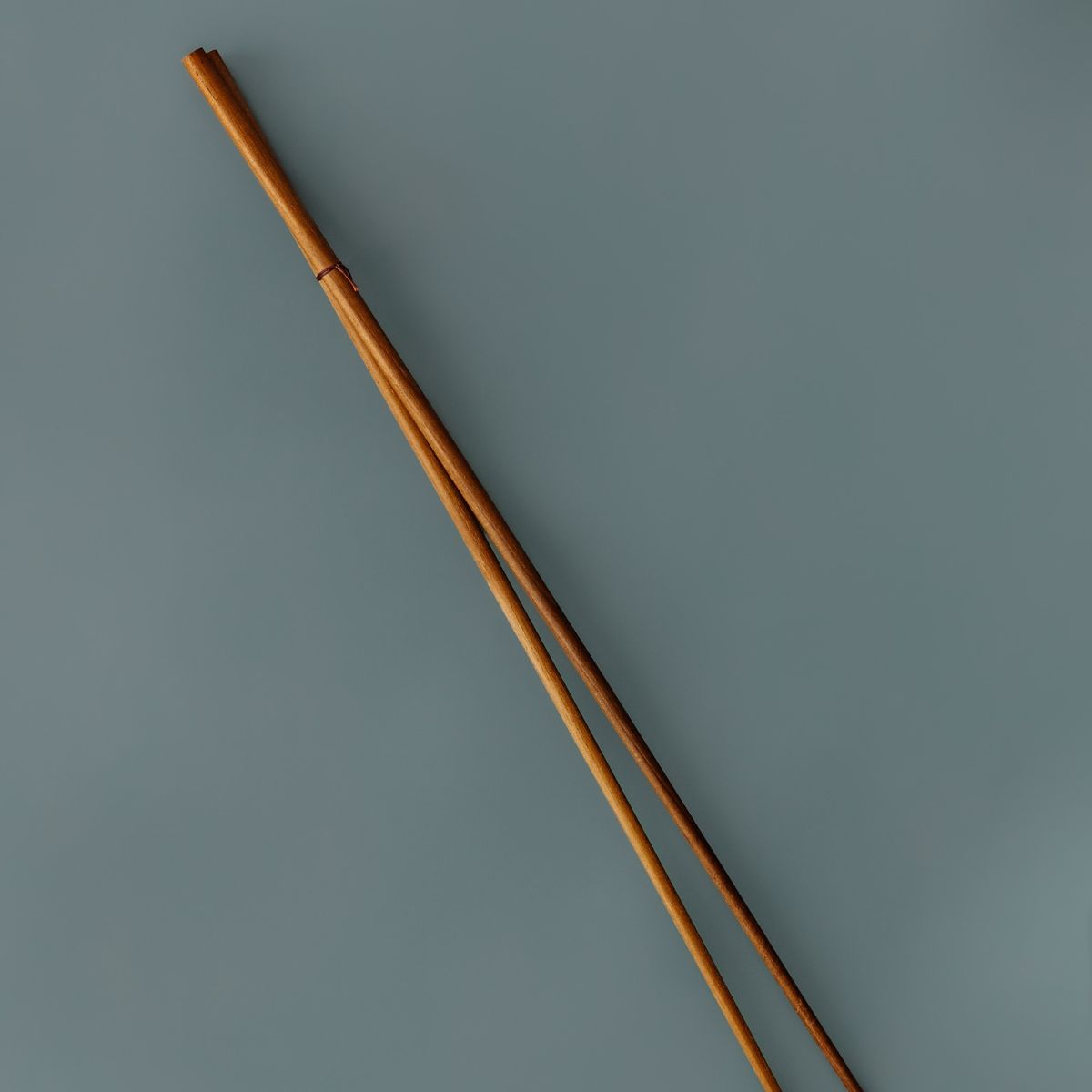 An elegant pair of long handled wooden cooking chopsticks