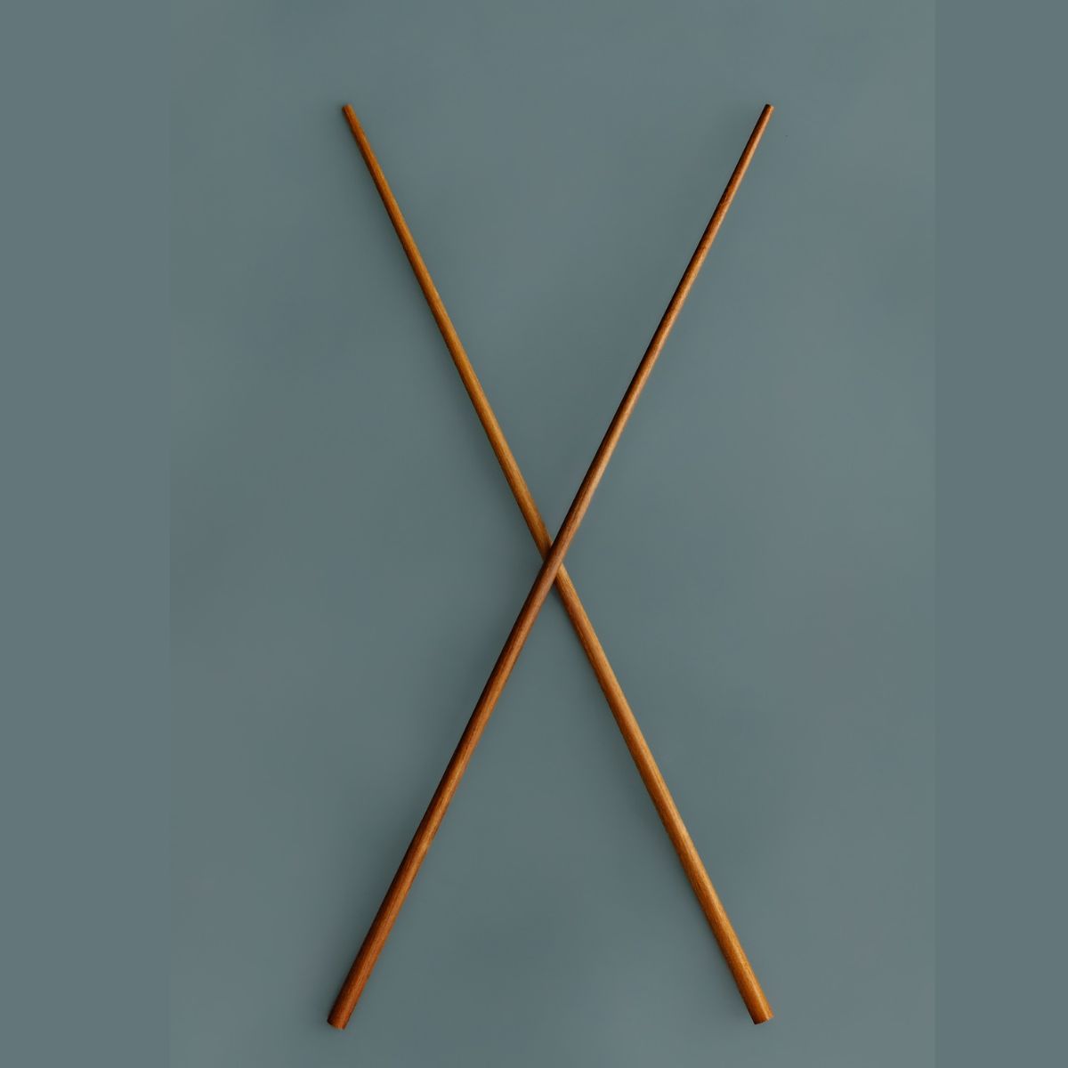 A pair of wooden cooking chopsticks in an X shape