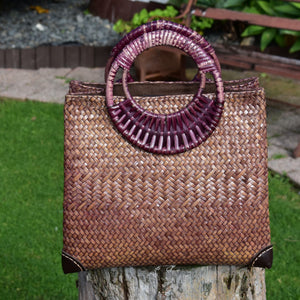 Handwoven Krajood bag with leather corner reinforcement, in a garden setting
