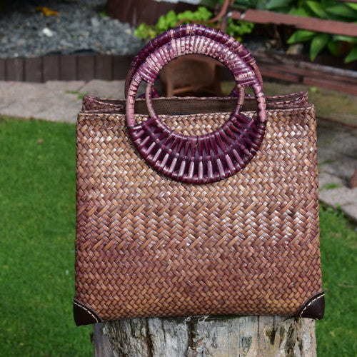 Handwoven Krajood bag with leather corner reinforcement, in a garden setting