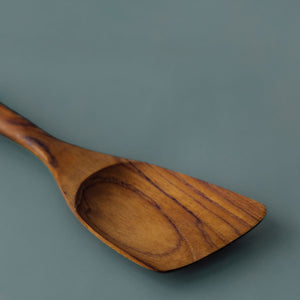 Close up of Left handed spatula blade, with the curve of the blade allowing a left handed user to stir, mix and turn food in pots in pans.