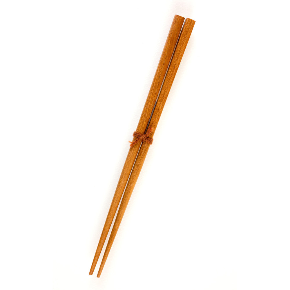 A pair of small 18cm wooden chopsticks made from natural teak wood, tied together with a simple brown twine against a white background.