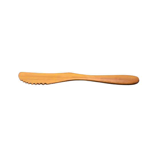 A handcrafted serrated knife made from solid teak wood, featuring a naturally sharp notched edge and a smooth ergonomic handle, ideal for slicing soft breads, cakes, or cheeses without sticking