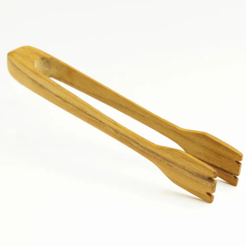A high-quality product shot of handcrafted teak wood toast tongs on a crisp white background, showcasing the rich golden-brown grain and smooth, food-safe finish of the artisanal kitchen tool.