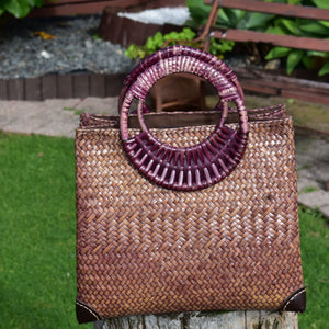 Handcrafted woven krajood bag with a cane handle, eco friendly, designed for casual situations
