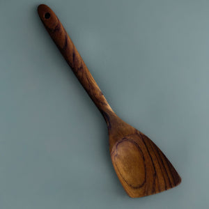 A handcrafted Teak wood angled spatula, designed for left handed people. 