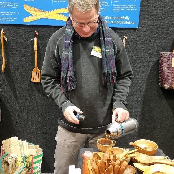 Paul pouring coffee into his wooden cup