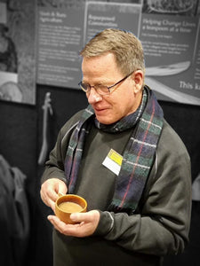 Paul with coffee in wooden cup