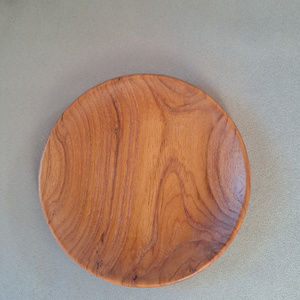small teak wood plate 15 cm in diameter, with a beeswax finish. ideal for side plates or small dishes of cheeses.