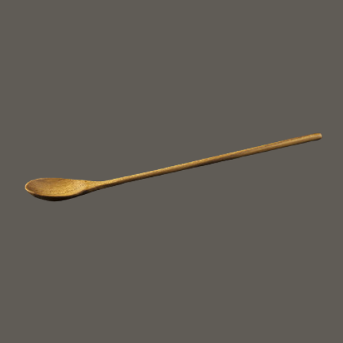 A low-angle lifestyle photograph of a handcrafted teak wood parfait spoon resting on a textured dark grey surface. The lighting emphasizes the slender 19 cm handle and the elegant curves of the spoon head, showcasing the warm, golden-brown grain of the sustainable teak wood. Carved from a single piece of timber, this durable and non-toxic spoon is an ideal culinary essential for stirring tall beverages or serving elegant desserts.