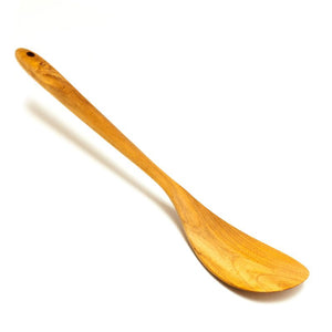 A handcrafted teak wood spatula with a uniquely rounded and curved head, designed for smooth stirring and easy flipping in contoured pans or woks. Carved from a single piece of premium golden-brown teak wood, it showcases a rich natural grain and a polished, food-safe finish. The long, slender handle features a pre-drilled hanging hole for convenient storage, making it a non-toxic and durable essential for an artisanal, eco-friendly kitchen