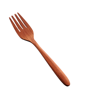 A professional product photograph of a handcrafted medium wooden fork, isolated diagonally against a seamless white background. The utensil features four precisely cut tines, a smooth head, and a tapered, ergonomically shaped handle carved from a single piece of sustainable teak wood. The image highlights the rich, warm reddish-brown timber tones and sublte natural grain, emphasizing its durable, non-toxic, and plastic-free design for daily dining.
