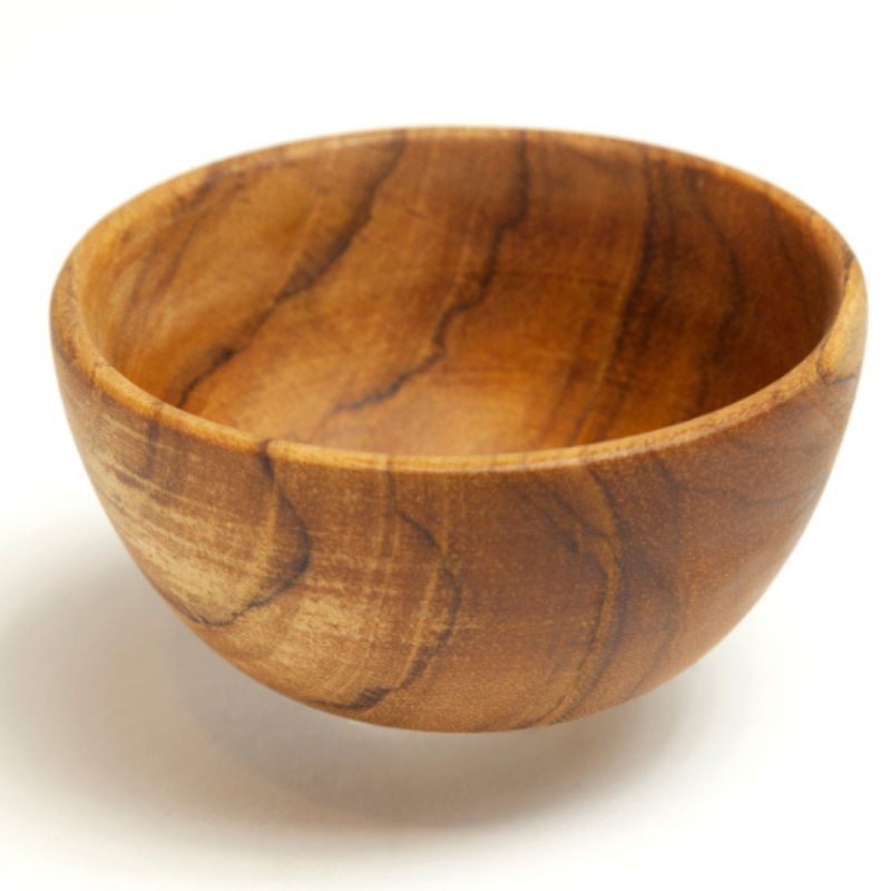 A handcrafted mini teak wood bowl, 8 cm in diameter, featuring a deep, rounded basin and a rich, swirling natural wood grain. Carved from a single piece of golden-brown teak, this small bowl has a smooth, food-safe finish and a stable base. It is the perfect sustainable size for use as a salt cellar, spice pinch pot, or for serving small garnishes in an eco-friendly, artisanal kitchen.