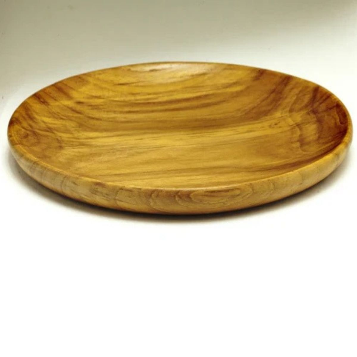 A beautifully handcrafted wooden platter,  35 cm in diameter, with a beeswax finish. Sustainably crafted and ideal for serving charcuterie, fruits and cheeses