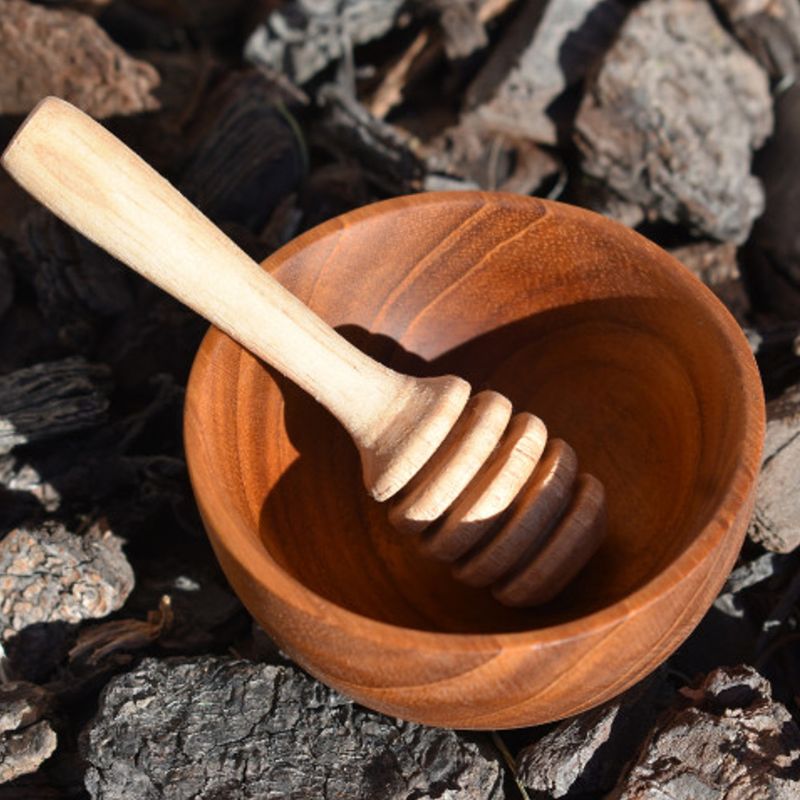 handmade wooden bowl with honey dipper
