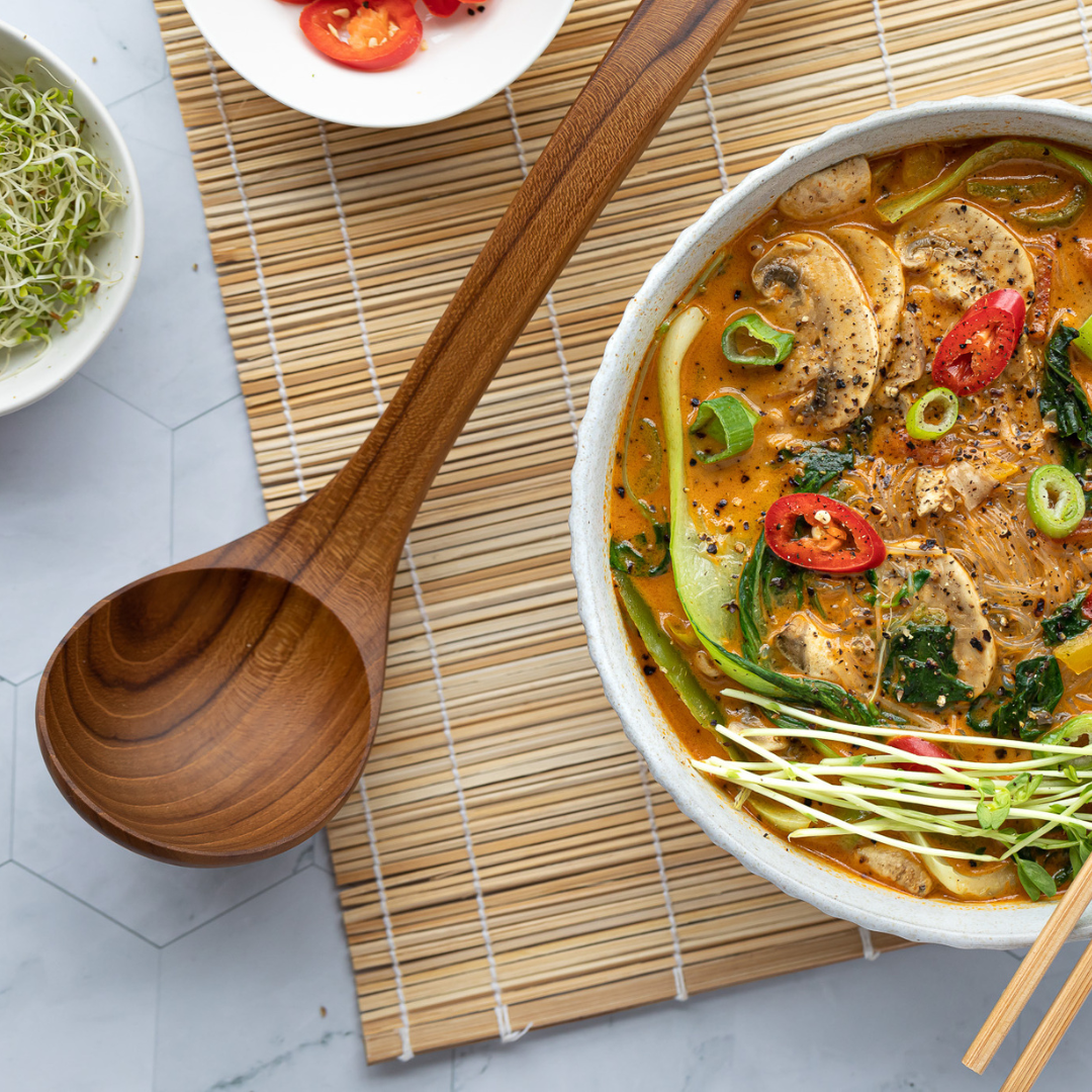 wooden ladle next to cooked dish