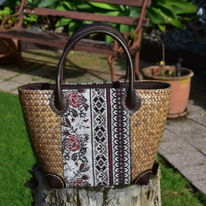 small handwoven bag with leather handles