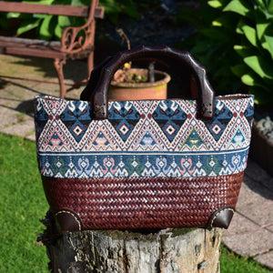 red brown handwoven bag with wooden handles