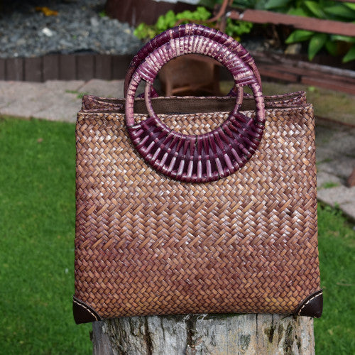 Handwoven bag with leather corner reinforcement
