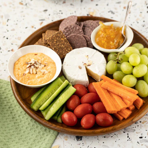 wooden platter serving dish 30 cm diameter with a selection of meats, fruit and cheeses, with different types of dip. Sustainably serving with elegance