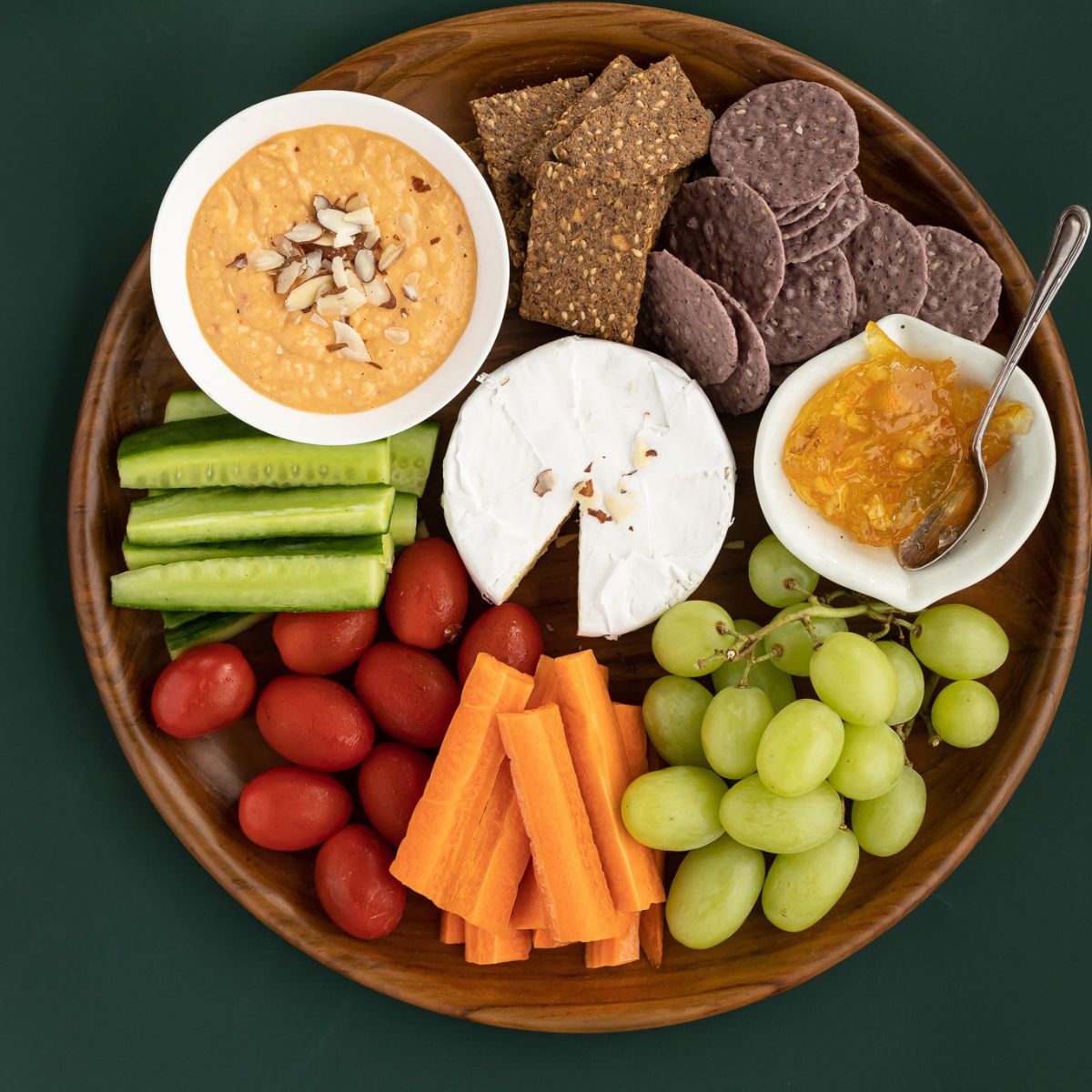 wooden platter serving dish 35 cm diameter with a selection of meats, fruit and cheeses, with different types of dip. Sustainably serving with elegance