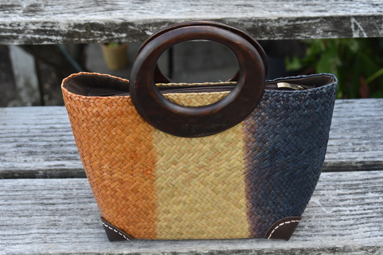 distinctive handwoven bag with dark wood handles