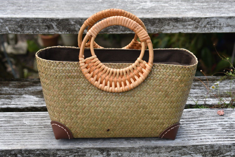 light woven bag with cane handles