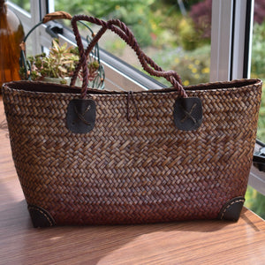 Brown handwoven bag with leather footers
