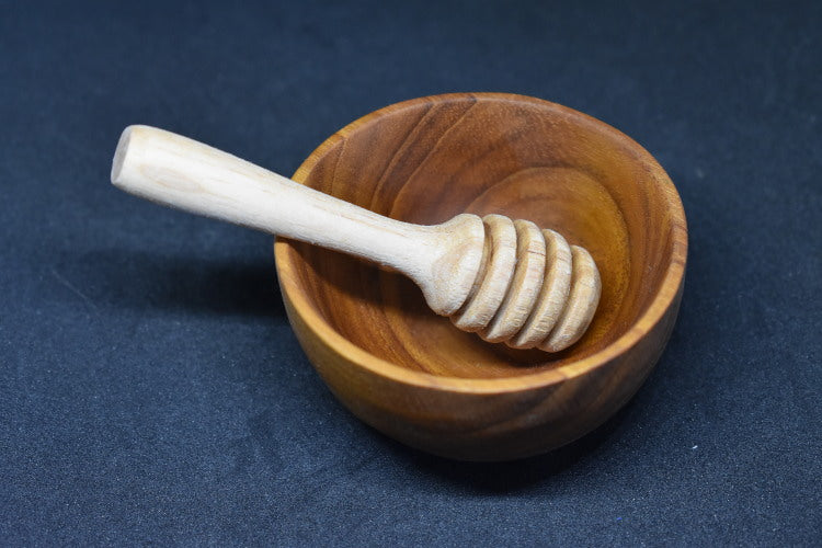 handcrafted wooden bowl and small wooden dipper
