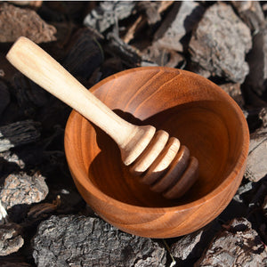 wooden bowl and small wooden honey dipper